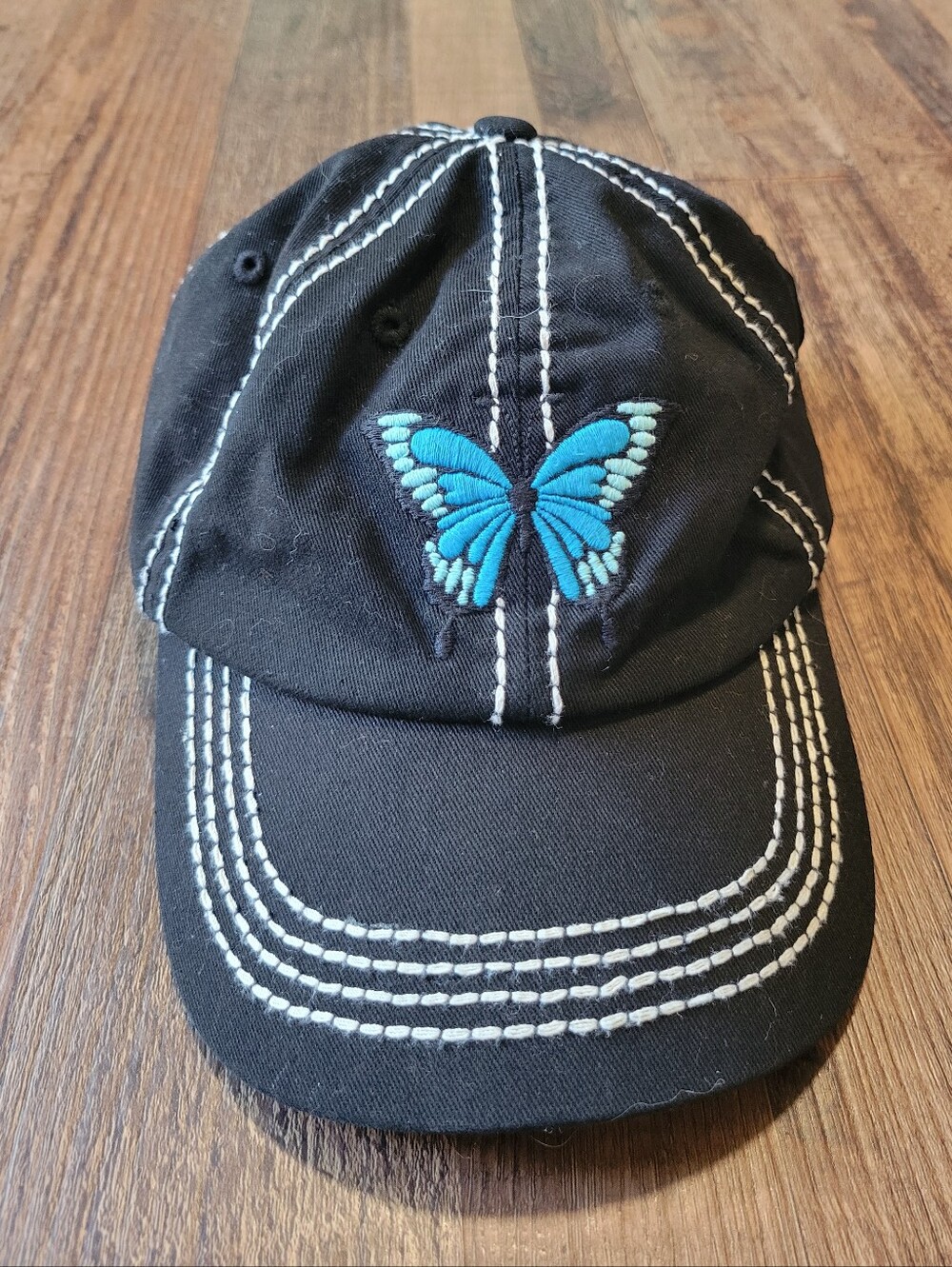 Black Baseball Cap With Contrast Stitching And Blue Butterfly Embroidery